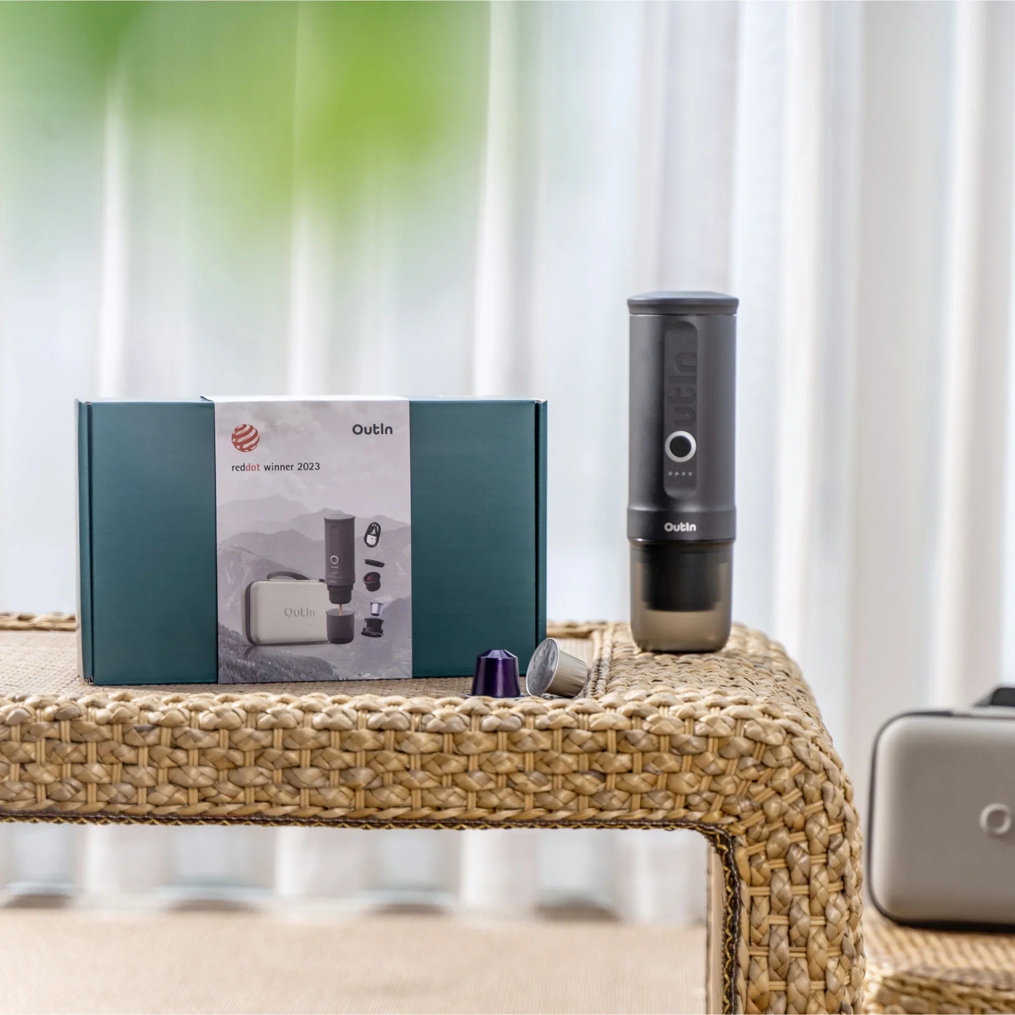 Space Grey OutIn Traveler Espresso Maker gift set with reddot winner 2023 packaging and protective case on table.