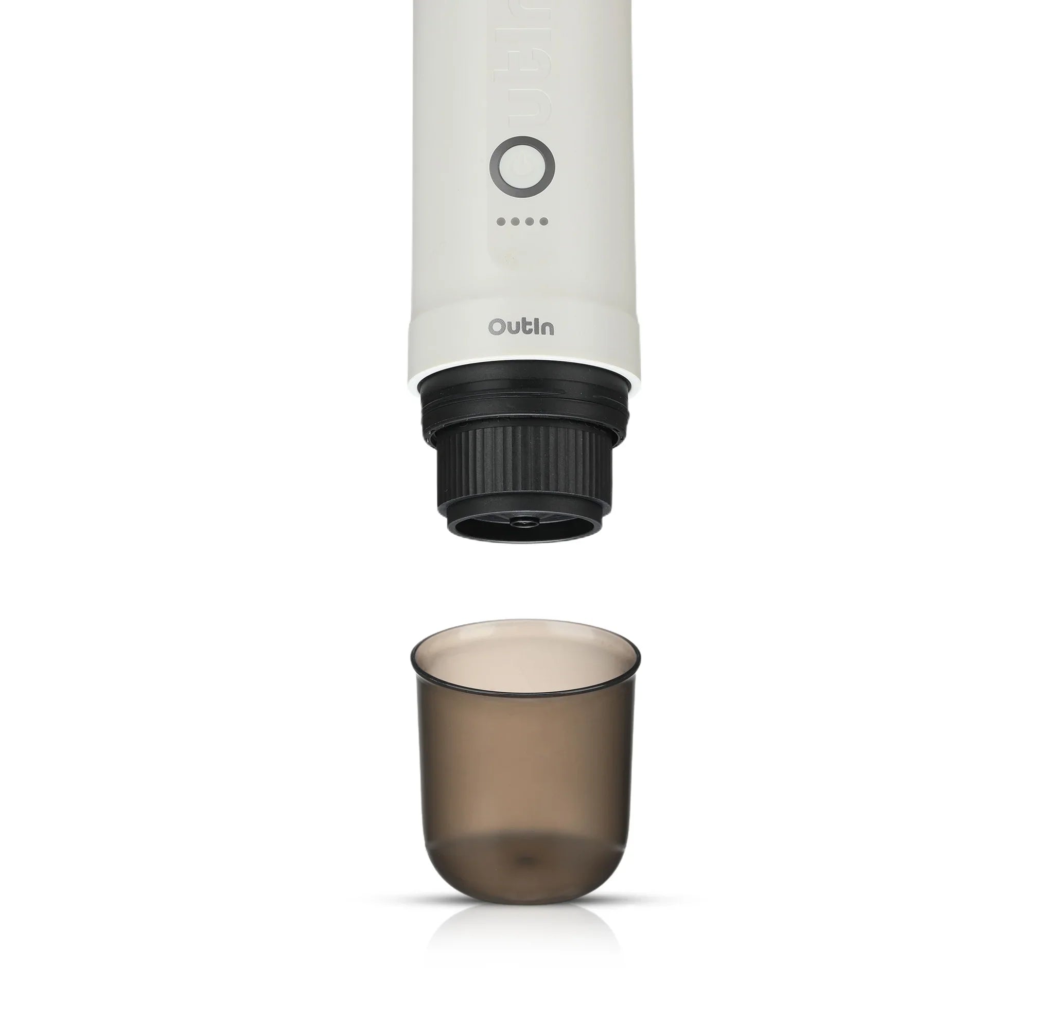 OutIn Nano portable espresso machine brewing head over translucent smoky grey BPA-free cup for outdoor use.