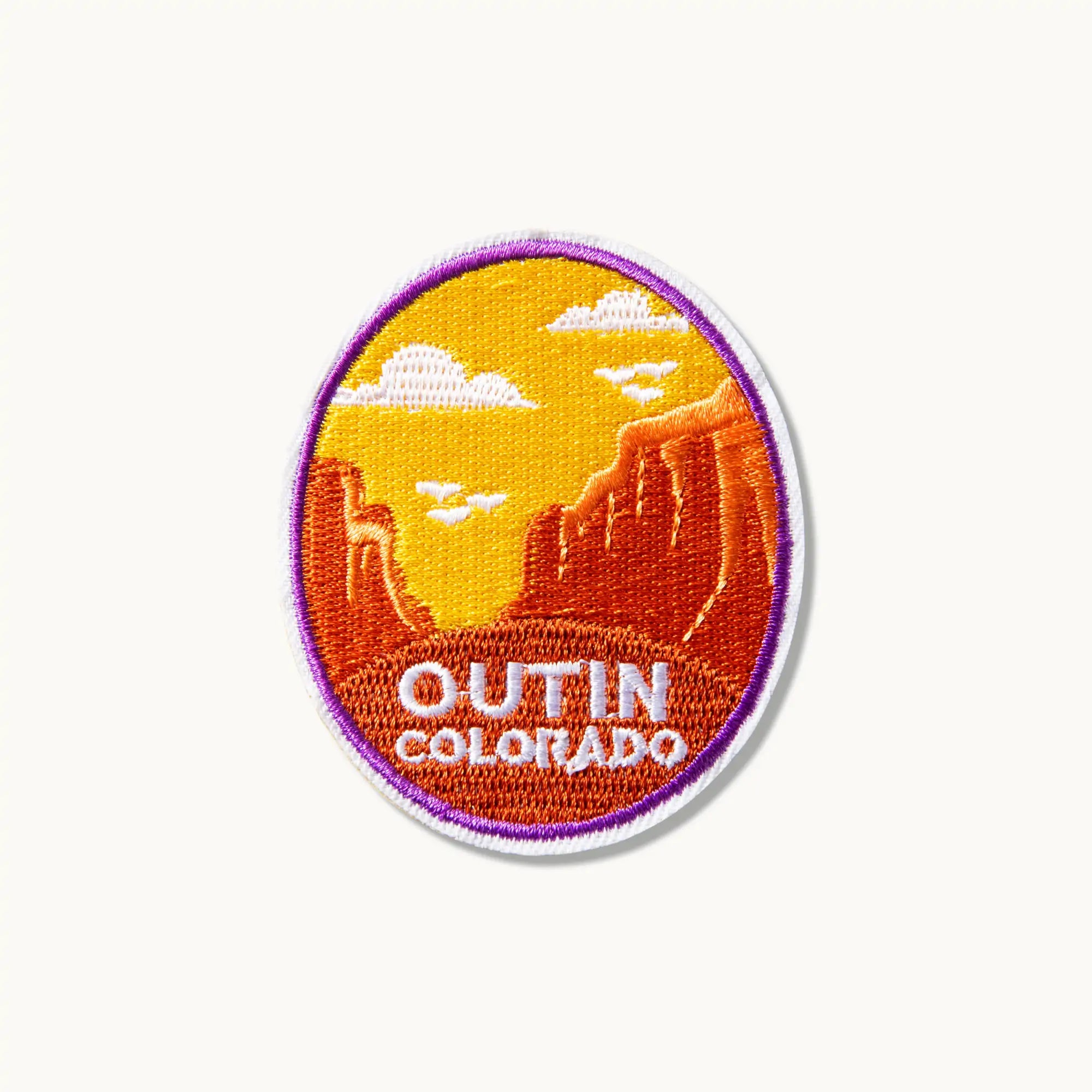 OutIn Colorado embroidered patch featuring a desert landscape with red rock formations and a vibrant sky.