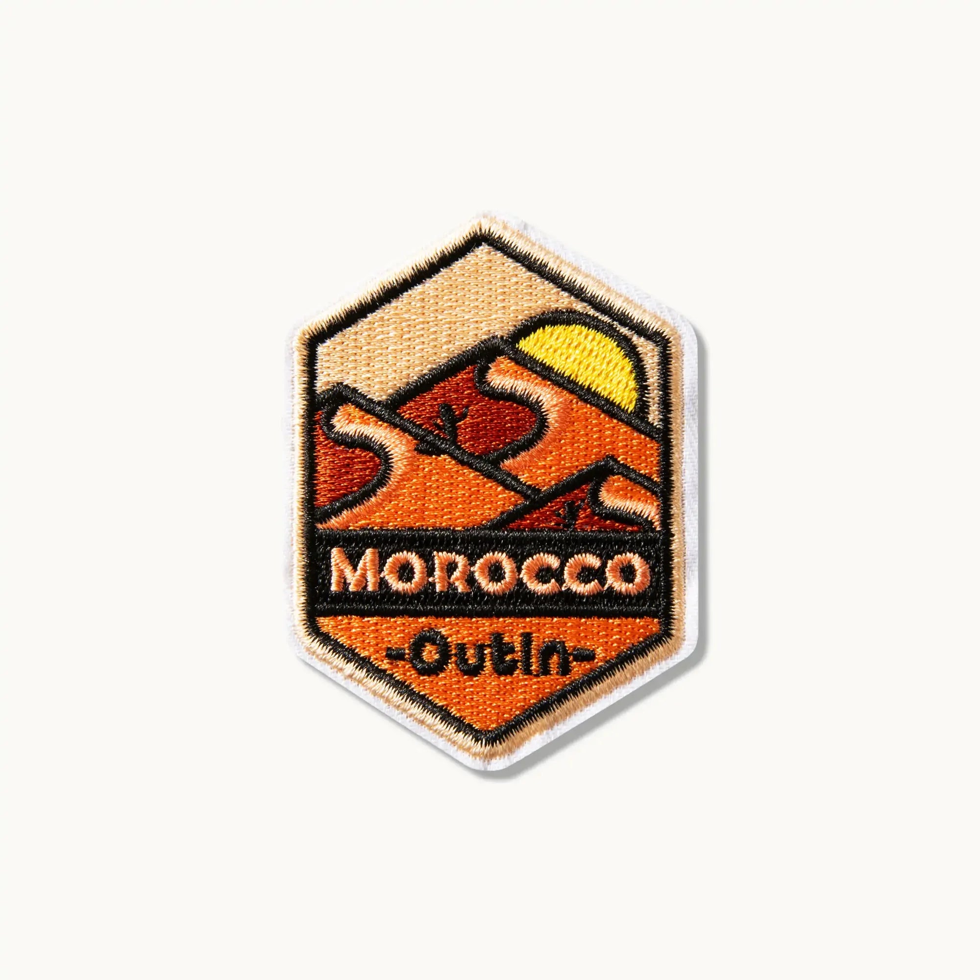 OutIn Morocco desert landscape embroidered patch with sun and dunes. Features 'MOROCCO' and '-OutIn-' text.