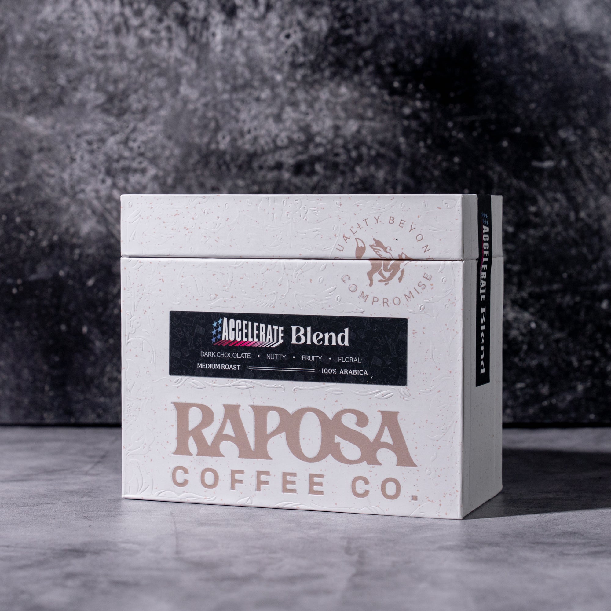 Raposa Coffee Co. coffee box with 'Accelerate Blend' label on a textured surface