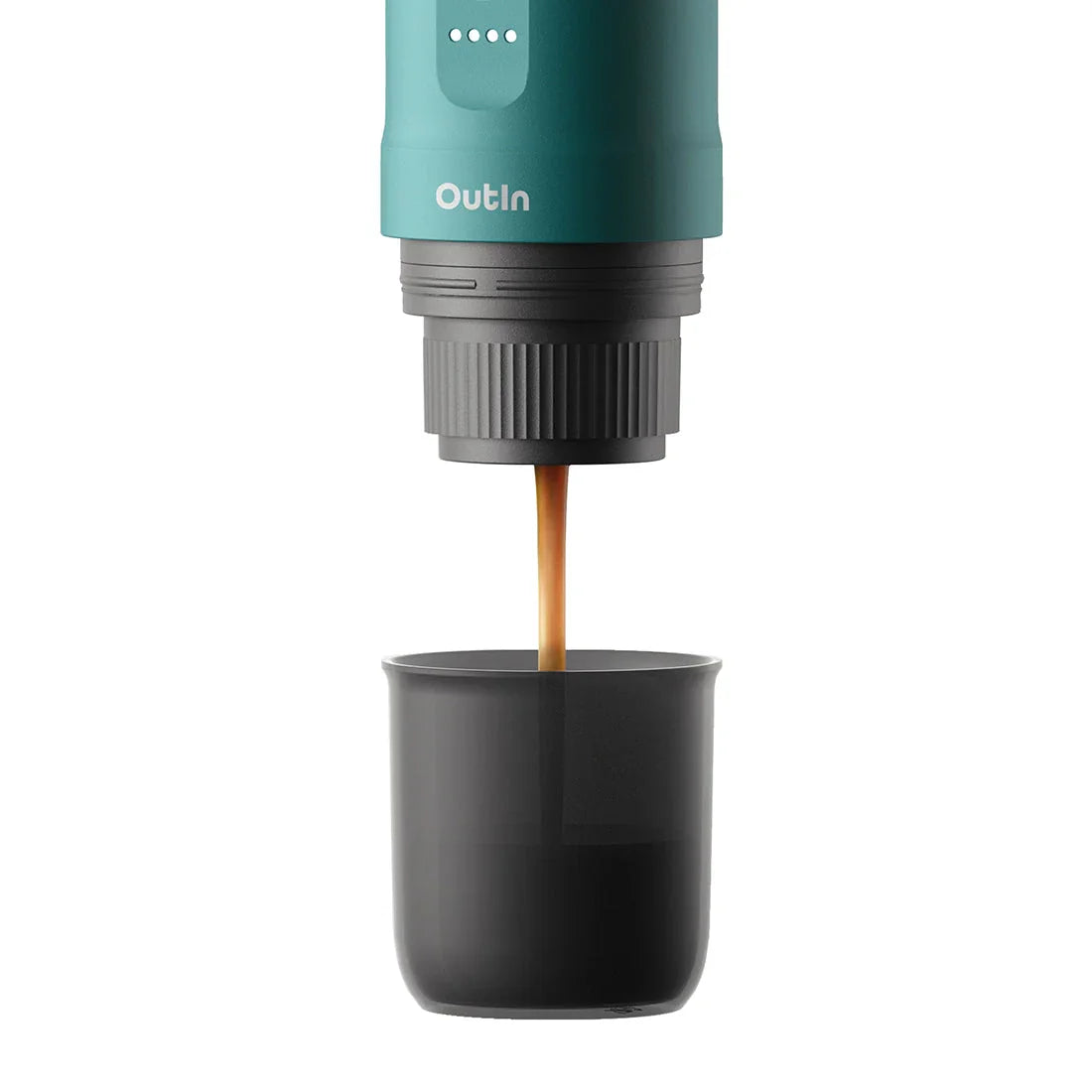 OutIn teal nano portable espresso machine brewing rich espresso into a black mug, product page.