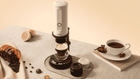 Outin grinder parts being assembled on dark surface