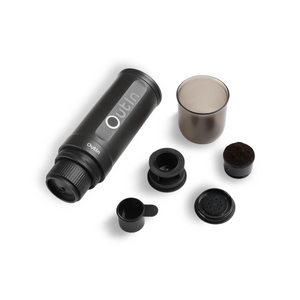 Outin Nano Portable Espresso Machine with coffee accessories.