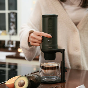 Brewing espresso with Outin machine on adjustable coffee stand.