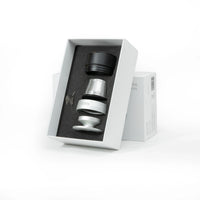 Nano Portable Espresso Machine Basket Plus accessory set in white box: black cap, stainless steel basket, tamper, spring.