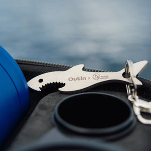 The Designed Shark-Shaped Keychain is placed on the protective case.