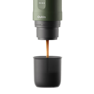 Forest green Nano Portable Espresso Machine brewing espresso into a black cup.