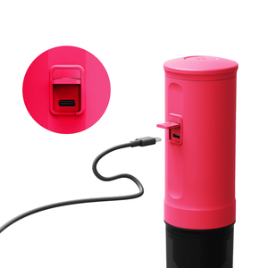 Fuchsia Nano Portable Espresso Machine charging with USB cable.